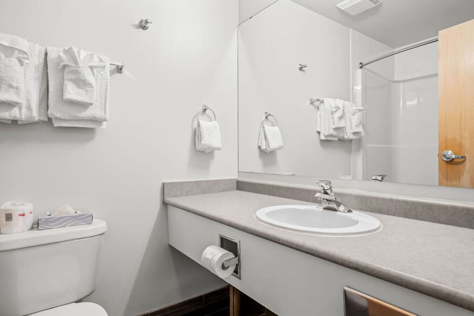 The full bathroom is equipped with all the essentials, featuring a refreshing hot and cold shower, a comfortable toilet, and a vanity area for your convenience.