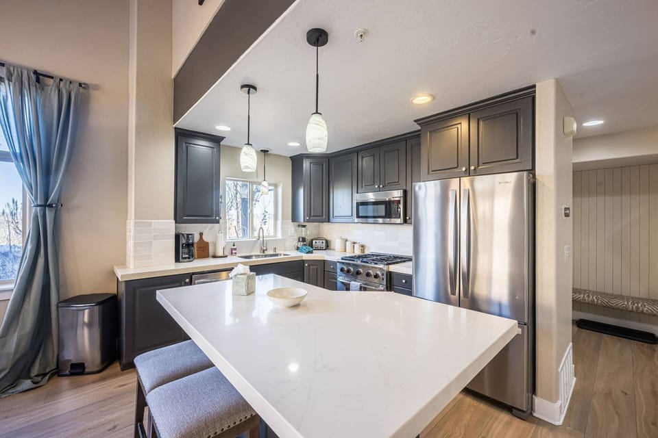 The kitchen has stainless steel appliances, plenty of counter space and a breakfast bar for a quick bite or meal prep.