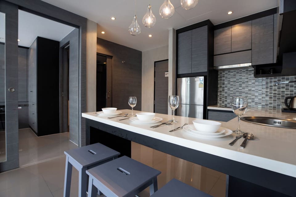 Deluxe Condo, Balcony, Pool View | Private kitchen | Full-size fridge, microwave, stovetop, highchair