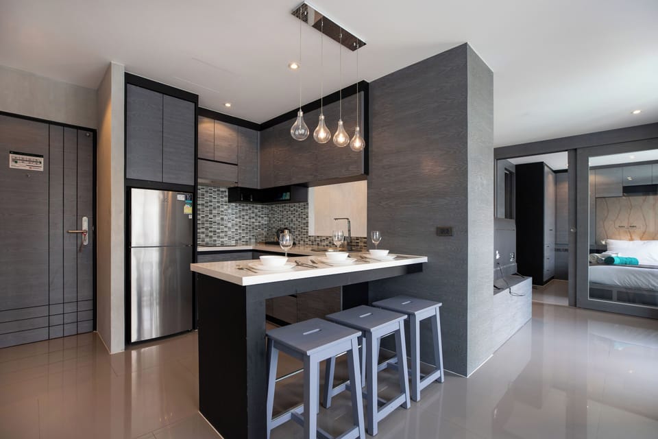 Deluxe Condo, Balcony, Pool View | Private kitchen | Full-size fridge, microwave, stovetop, highchair