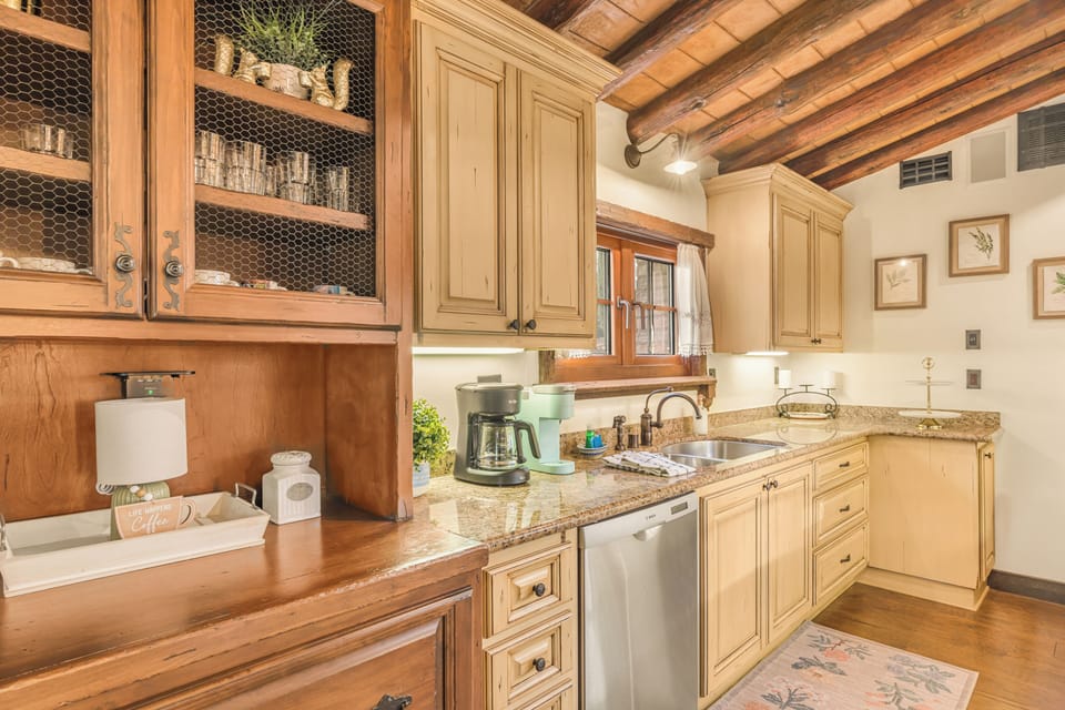 A chef-inspired kitchen blends stone walls, exposed beams, and a statement island—perfect for slow mornings and wine-country feasts.