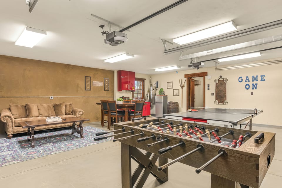 Spacious game room with foosball, ping pong, and lounge seating—perfect for friendly competition and laid-back hangouts.