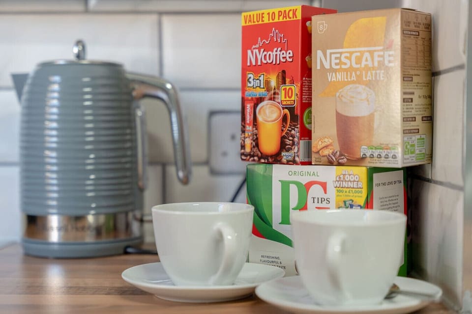 Tea and coffee setup on the kitchen counter with cups ready to use.