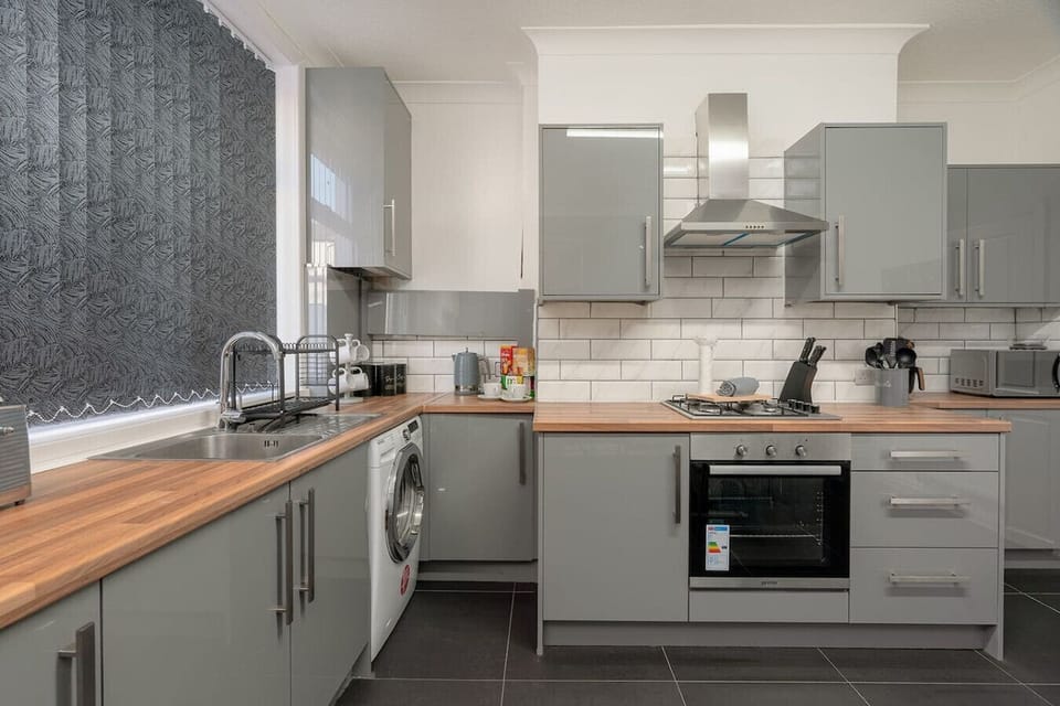 Corner view of the kitchen showing countertops, sink area, and appliances.