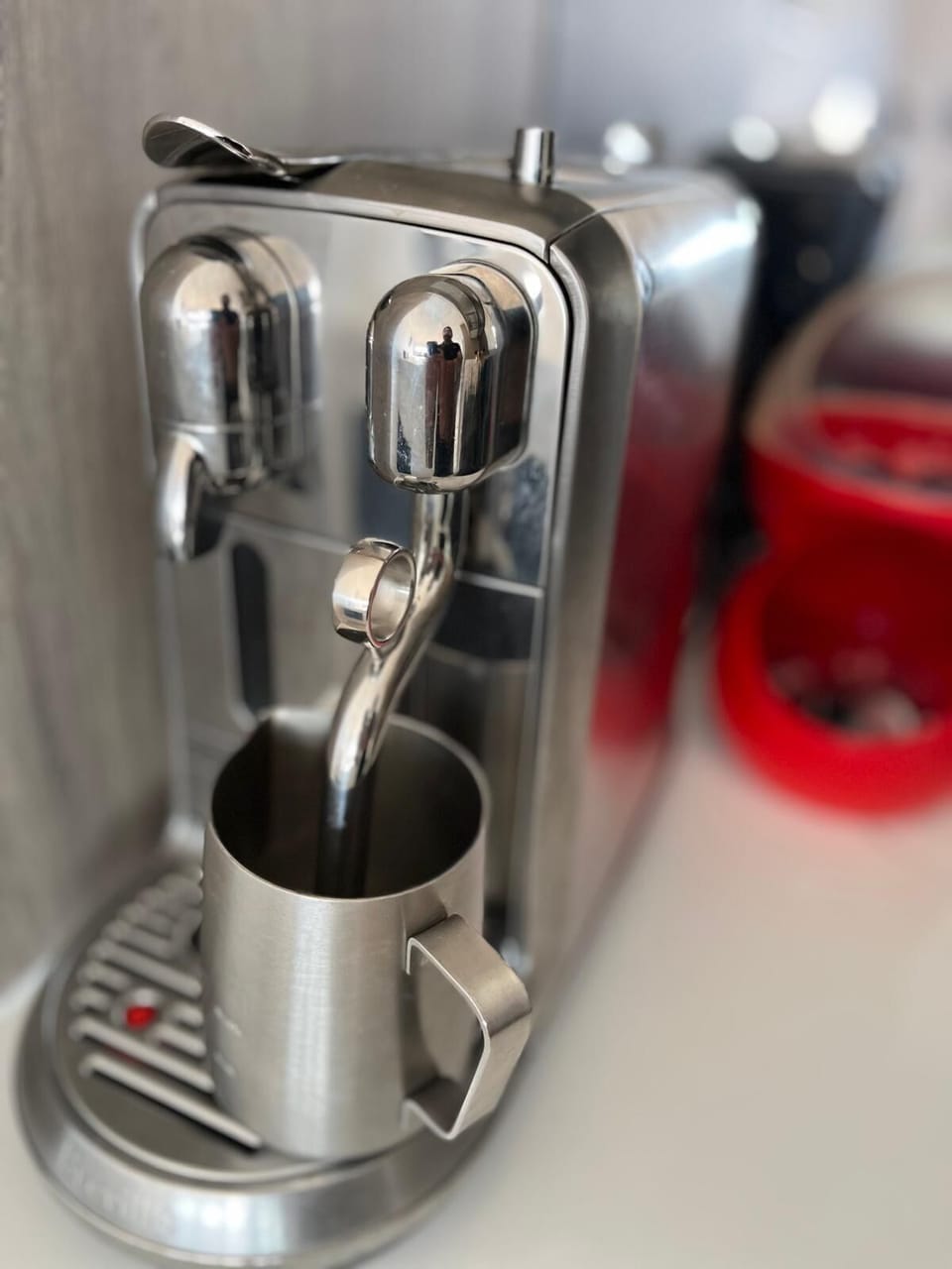 Nespresso Creatista coffee machine with steaming wand and a variety of pods