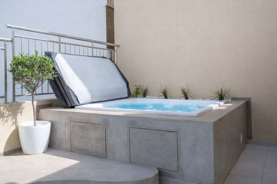 Private Rooftop Jacuzzi with Sun Deck and Greenery