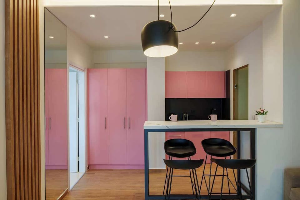 Contemporary Kitchen and Dining Area with Pink Accents