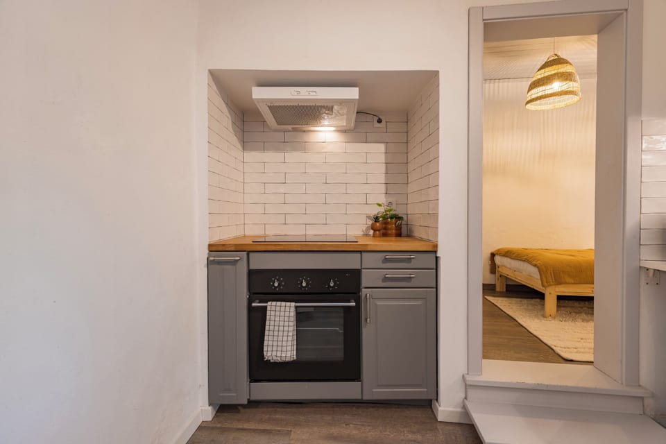 Classic Townhome, Garden View | Private kitchen | Mini-fridge, microwave, stovetop, dishwasher