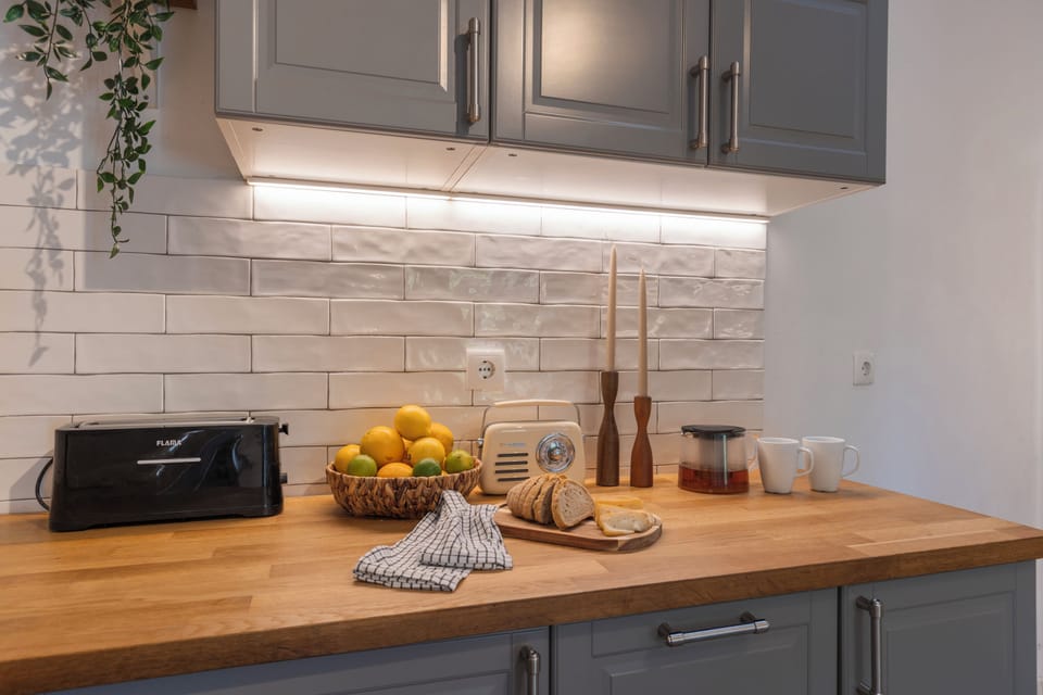 Classic Townhome, Garden View | Private kitchen | Mini-fridge, microwave, stovetop, dishwasher