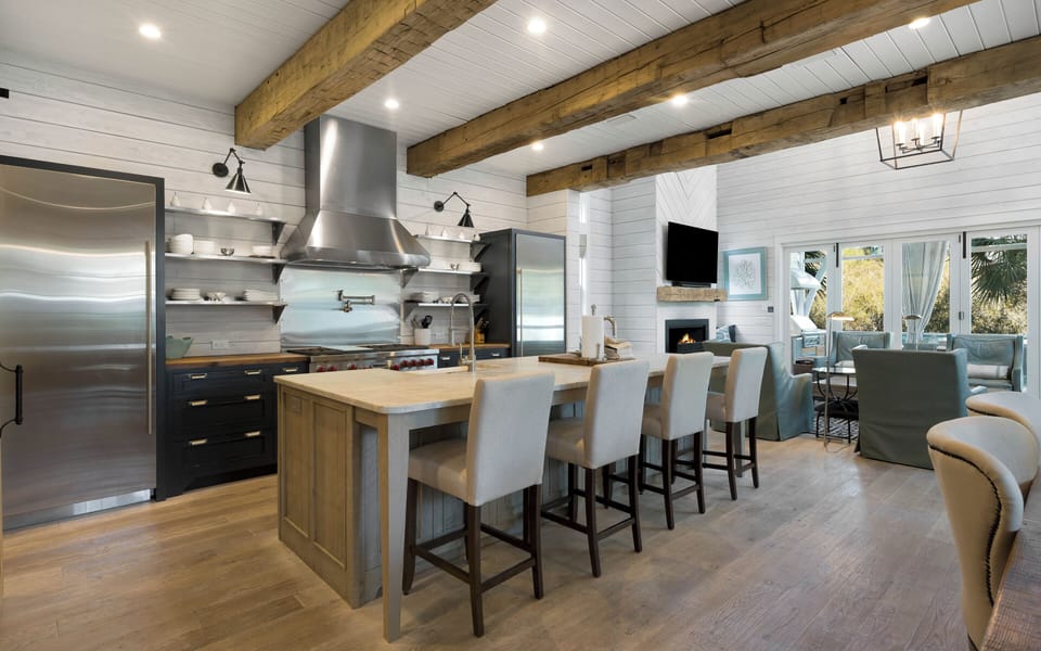 You'll love cooking in this stunning gourmet kitchen featuring exposed beams, premium appliances, and island seating for memorable meals together.