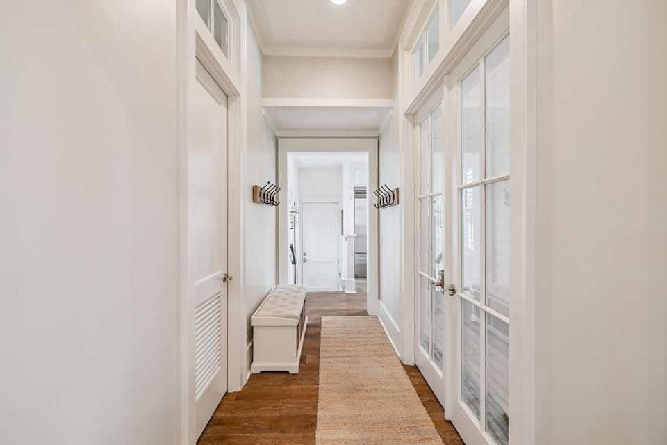 Your spacious walk-in closet offers abundant storage with custom built-ins and warm wood floors for organizing your getaway wardrobe.