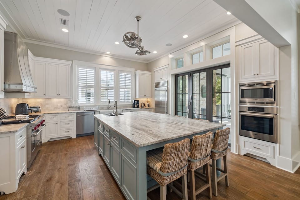 Your gourmet kitchen awaits with marble countertops, professional appliances, and a spacious island perfect for morning coffee or evening meal prep.