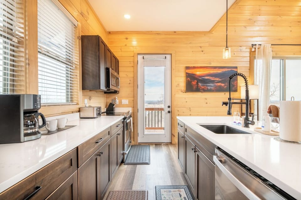 Your fully equipped kitchen awaits with sleek countertops, modern appliances, and warm wood accents for memorable meal prep.