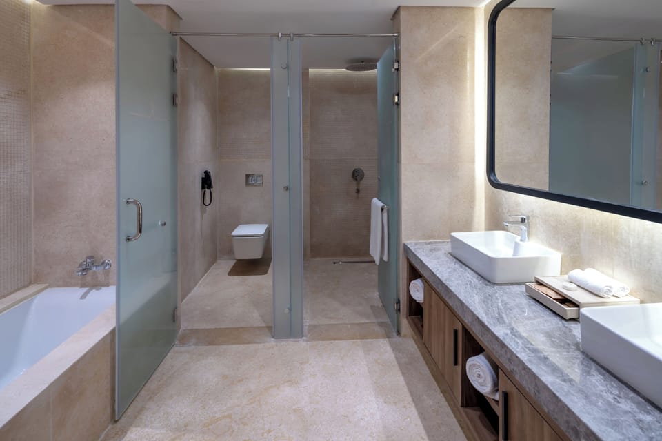 Superior Room | Bathroom | Rainfall showerhead, designer toiletries, hair dryer, bathrobes