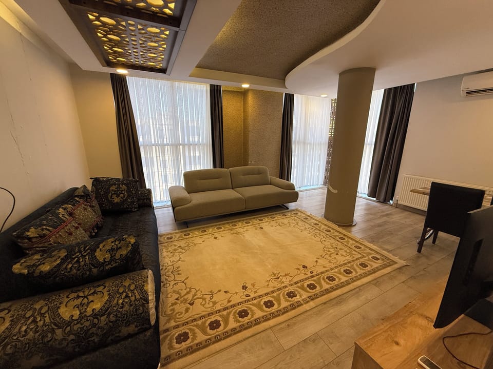 Deluxe Apartment, City View | Living area | TV