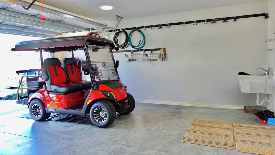 Your private garage features a convenient golf cart and utility sink, perfect for easy transportation and storage needs during your stay.