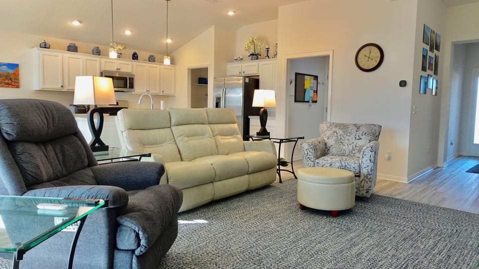 Sink into plush seating in this open-concept living space where comfort meets style. Your perfect retreat awaits with cozy furnishings and thoughtful touches.