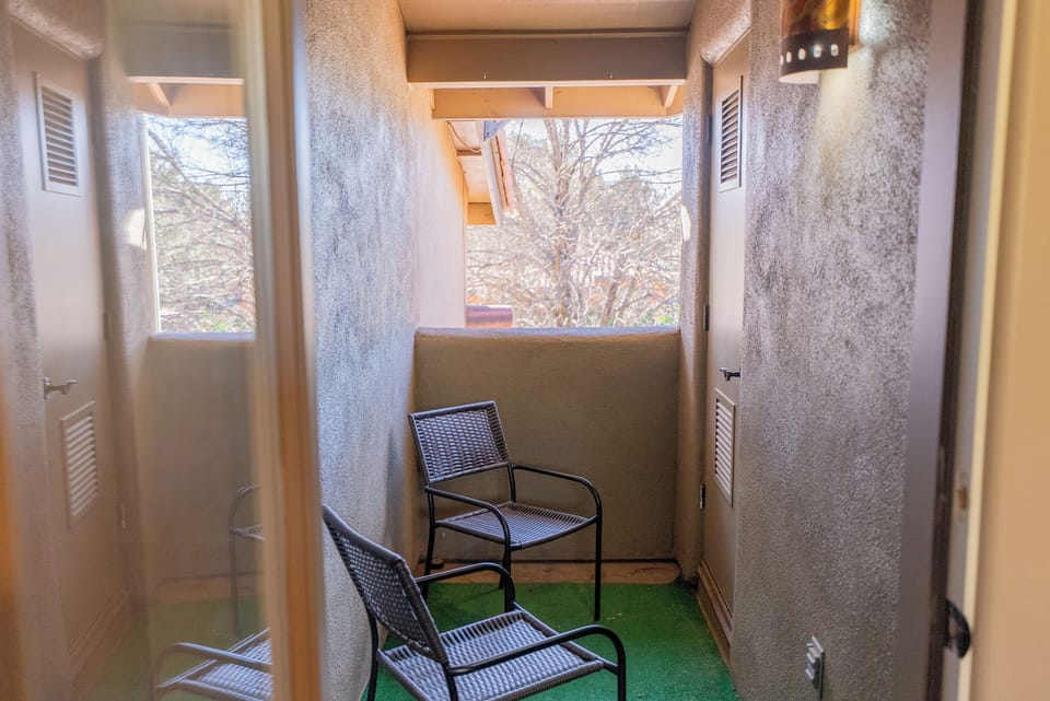 Your private balcony awaits with comfortable seating and lovely garden views for peaceful morning coffee or evening relaxation.