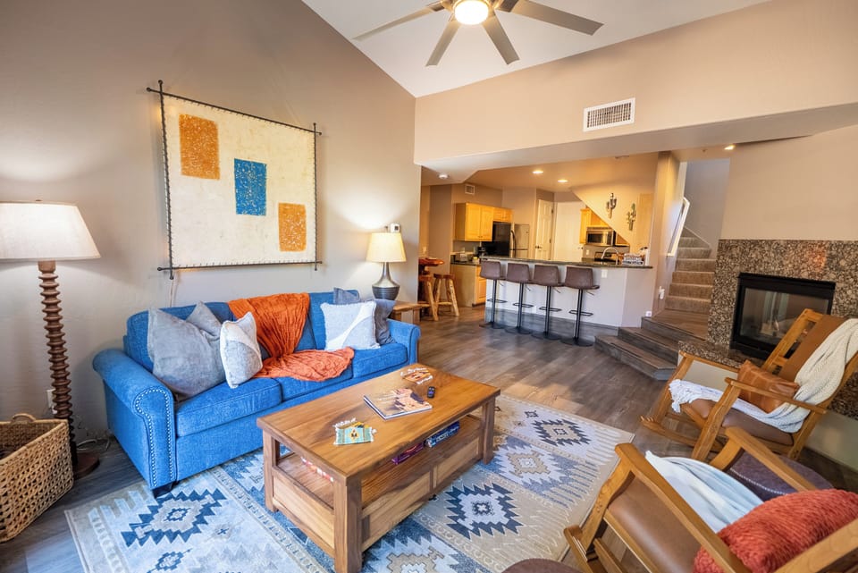 Relax in your stylish open-concept living space with sleeper sofa, cozy fireplace, and fully-equipped kitchen just steps away.
