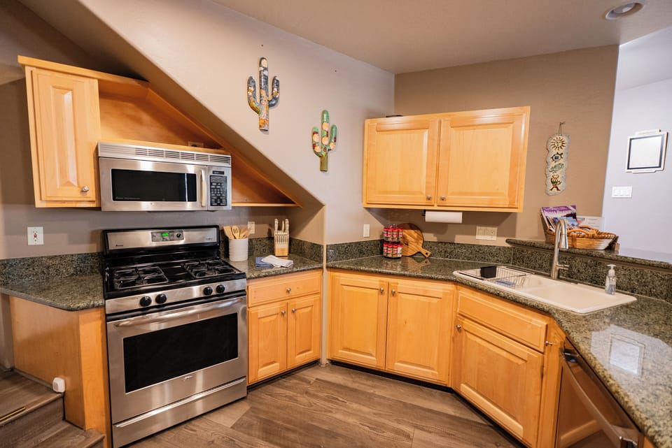Your fully equipped kitchen features granite counters and stainless appliances, ready for preparing meals.
