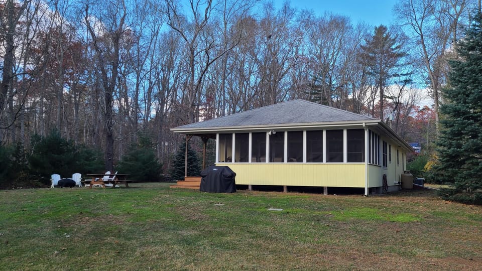Front of Cabin with outdoor seating and firepit.
