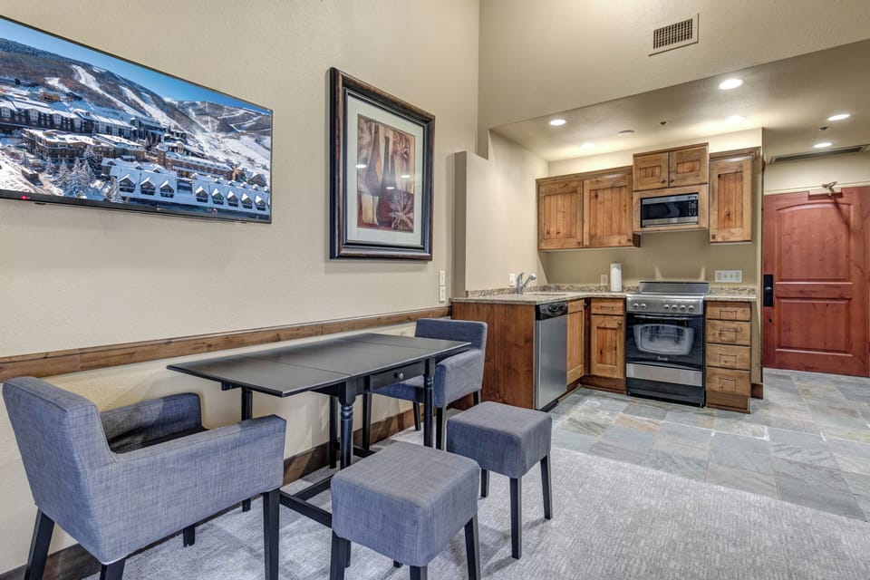 The open concept living space with a dining area with seating for two guests.