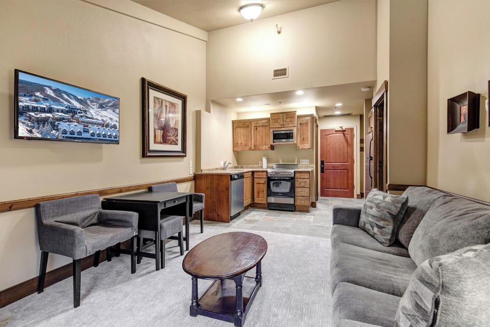 Sink into your plush sofa while enjoying the open-concept layout connecting your cozy living space to your fully equipped kitchen.
