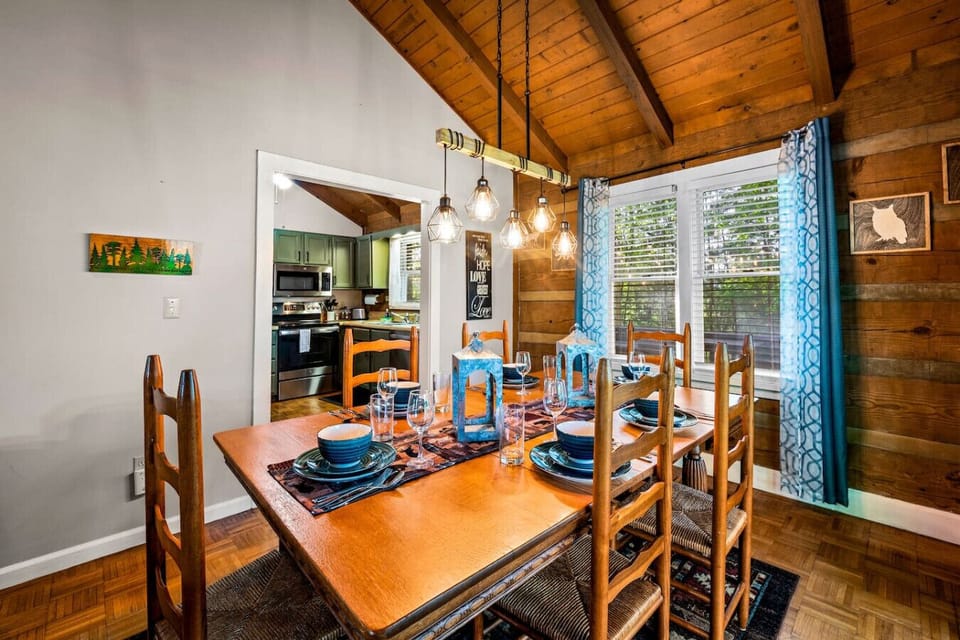 Set beneath vaulted wood ceilings and warm pendant lighting, this dining table invites long meals, laughter, and memories. Perfect for game nights or hearty breakfasts before mountain adventures.