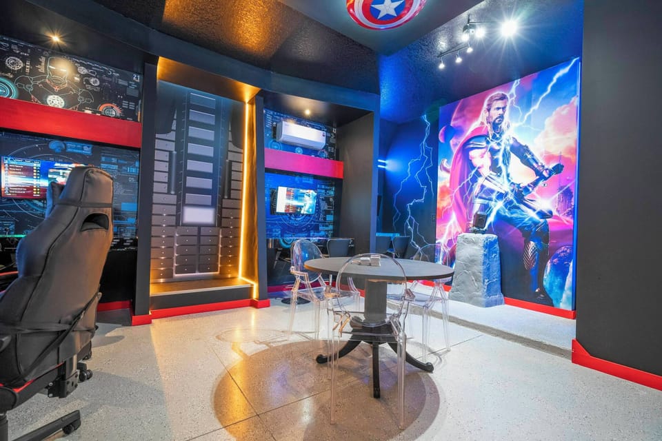 Step into this vibrant gaming room where a striking mural sets the stage for fun. The sleek gaming chairs and modern desks create a dynamic atmosphere, ensuring an exciting retreat for both gamers and casual visitors alike.