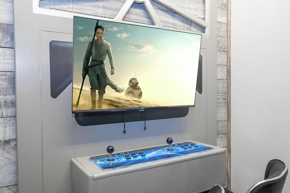 Enjoy a unique entertainment experience with a sleek wall-mounted TV and a striking blue console, ideal for gaming or movie nights. Its contemporary design adds a stylish touch, making your leisure time both fun and enjoyable.