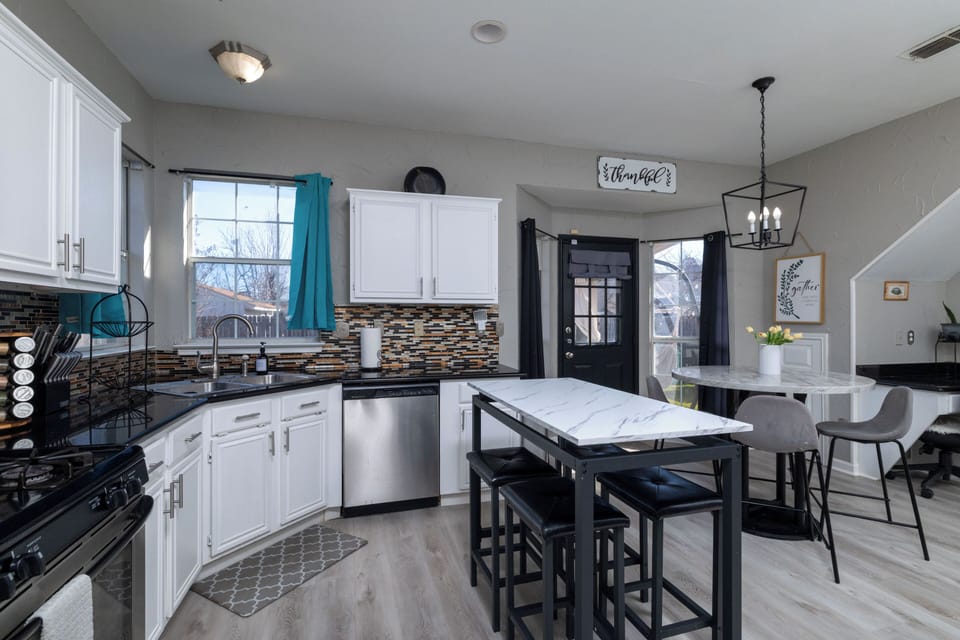 Bright, modern kitchen with a sleek island and cozy dining area.
