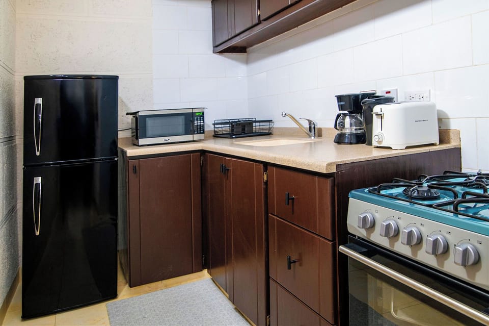 Studio, 1 King Bed | Private kitchen | Full-size fridge, microwave, toaster, cookware/dishes/utensils