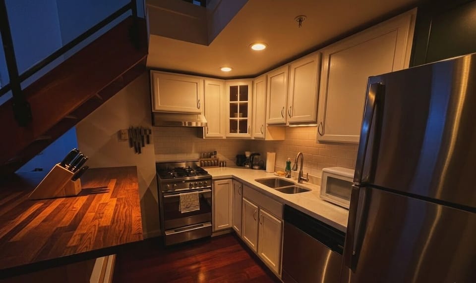A full kitchen, cozy lighting, and a sleek modern design perfect for relaxing.