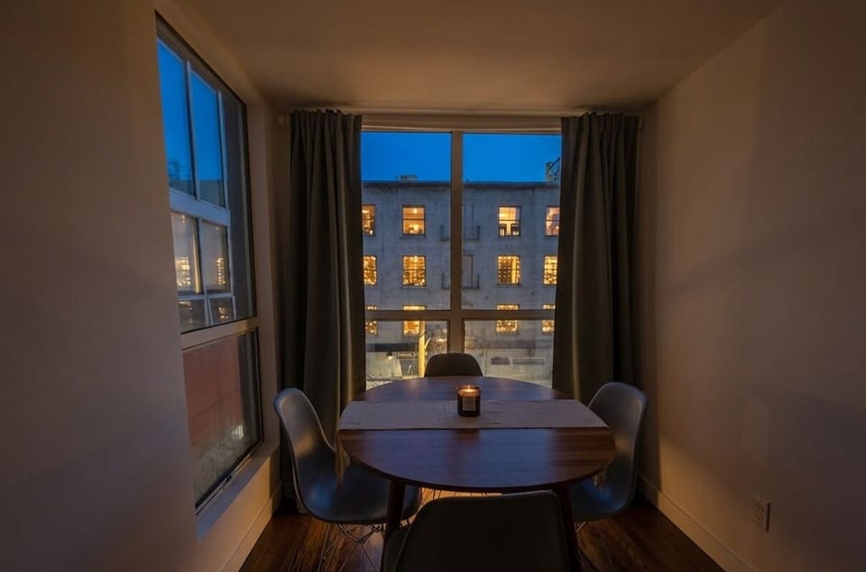 This is a dining or workspace featuring a window with natural light.