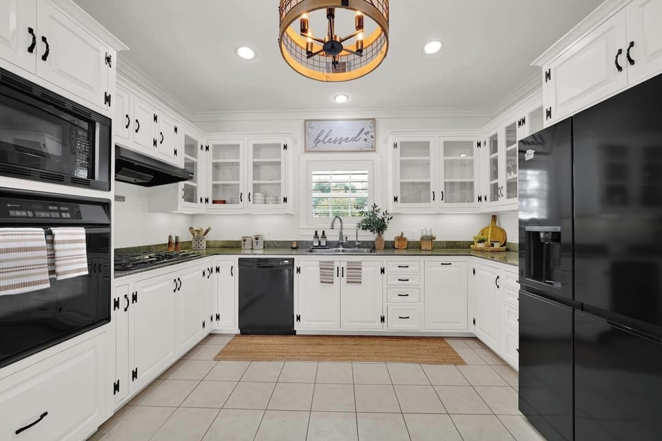 Complete kitchen in the main house with all the essentials, including an oven, microwave, dishwasher, and pantry.