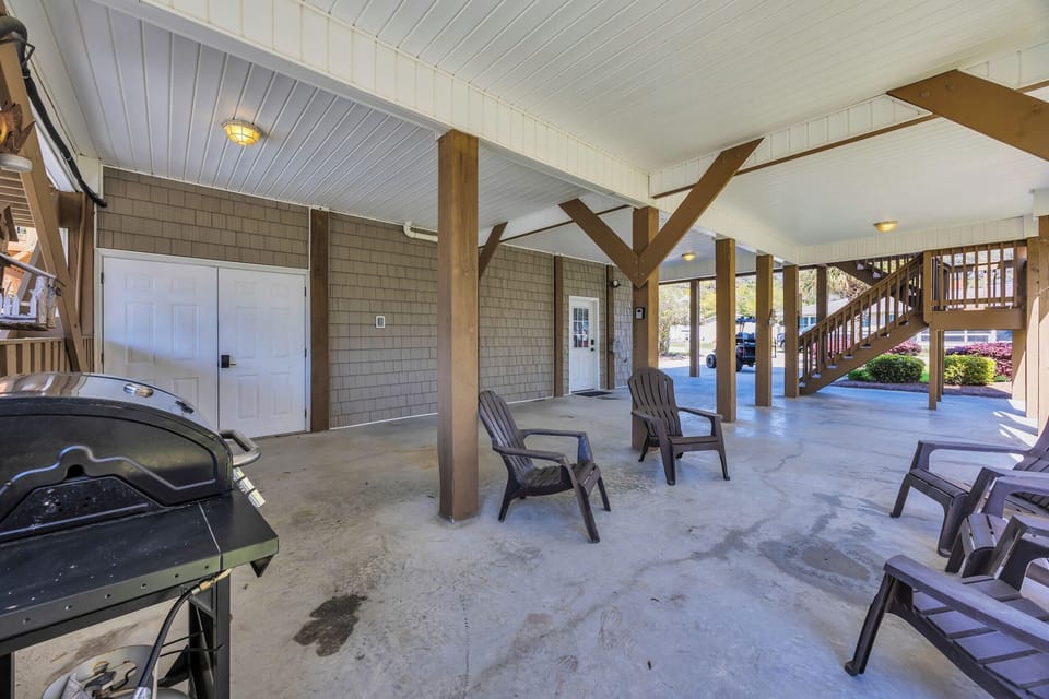 Spacious covered patio with seating and grill for outdoor fun