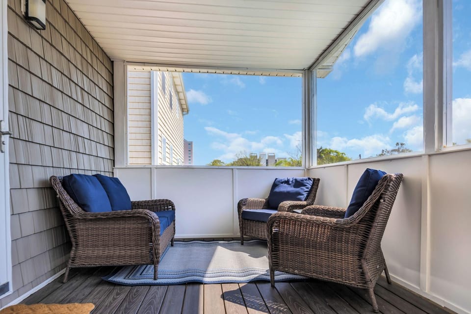 Cozy screened porch with comfortable seating and fresh air views