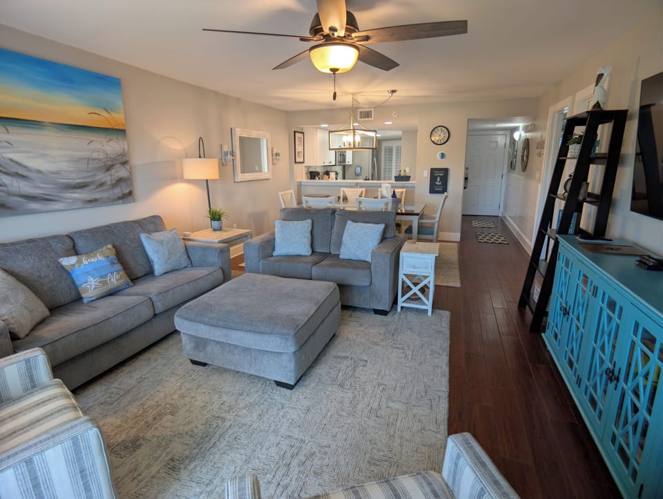 Coastal-chic lounge with plush seating for 7 plus, dining area, and smart TV.