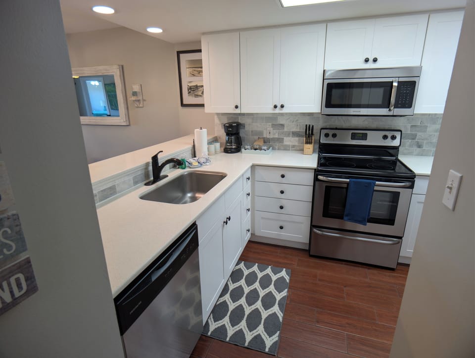 Kitchen with solid surfaces, stainless appliances, coffee station and much more
