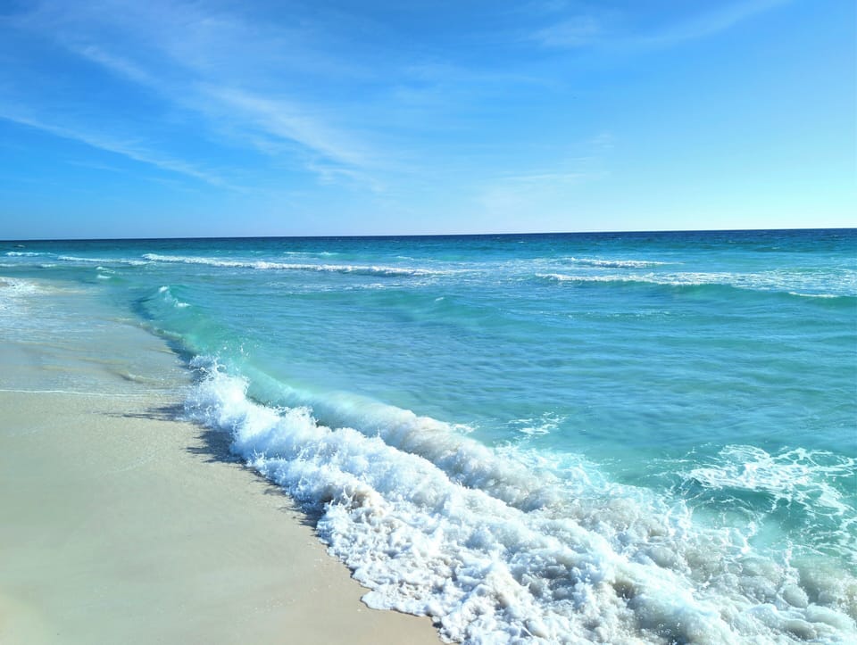 White sand beach emerald waters, just steps away