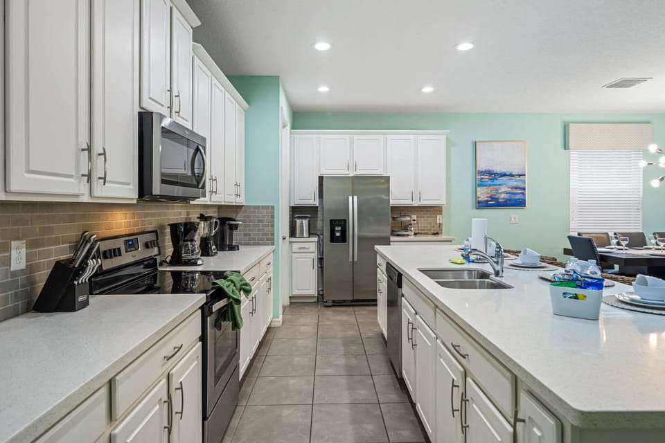 The fully equipped kitchen is perfect for group meals and casual entertaining, featuring modern appliances, ample counter space, and everything you need to prepare breakfast, dinner, or snacks for the whole family.