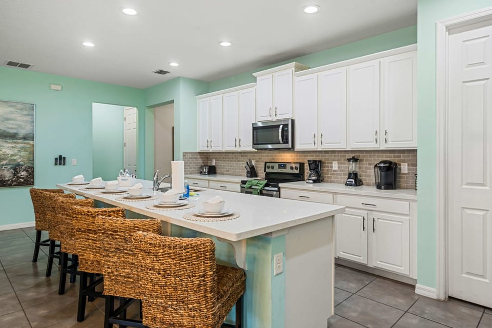 The fully equipped kitchen is perfect for group meals and casual entertaining, featuring modern appliances, ample counter space, and everything you need to prepare breakfast, dinner, or snacks for the whole family.