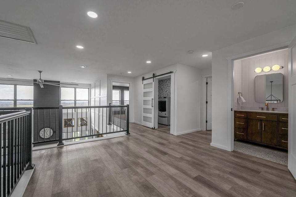 Bright upper-level landing with plenty of space to move around and a beautiful open view overlooking the main level.