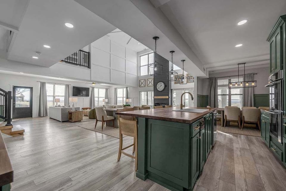 Enjoy a bright open-concept space where the kitchen, dining, and living areas flow together under soaring ceilings.
