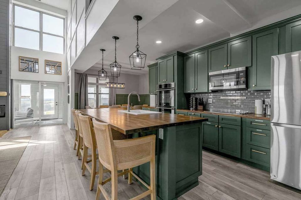 Gather around this stunning kitchen island featuring modern appliances, stylish lighting, and plenty of space for meals and conversation.