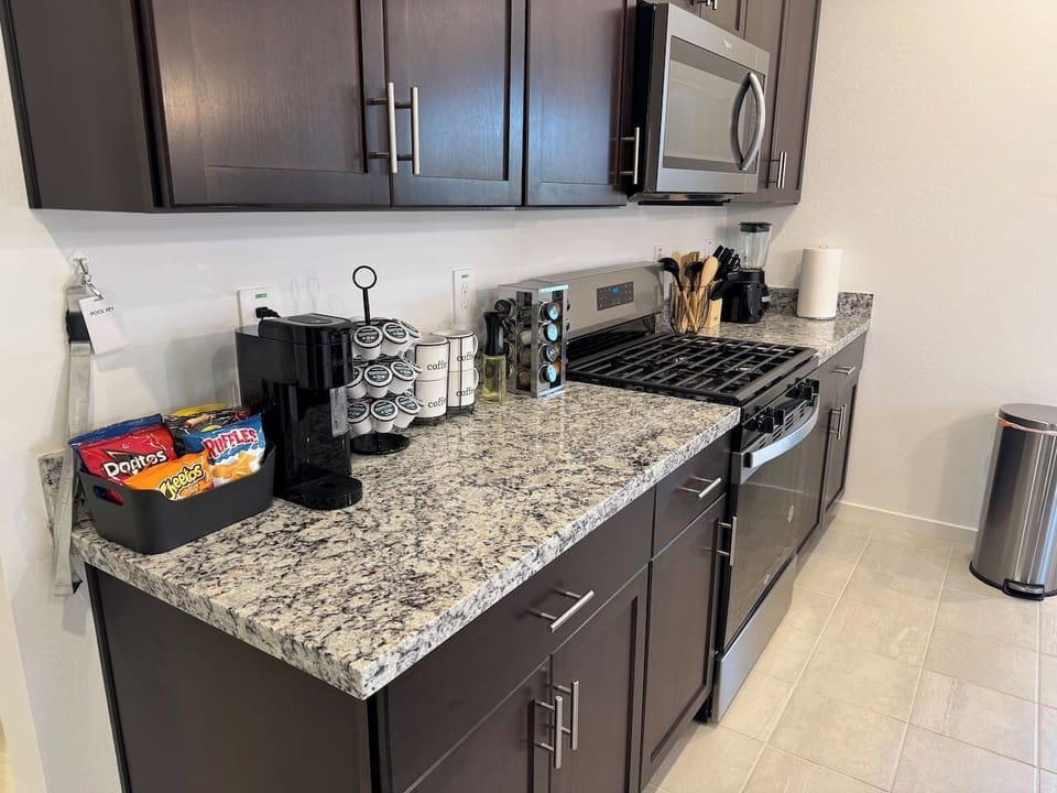 Kitchen counter with coffee maker, toaster, and dark cabinets