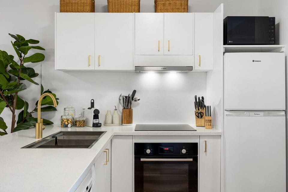 Prepare meals with ease in this bright, modern kitchen, fully equipped with everything you need for easy cooking at home.
