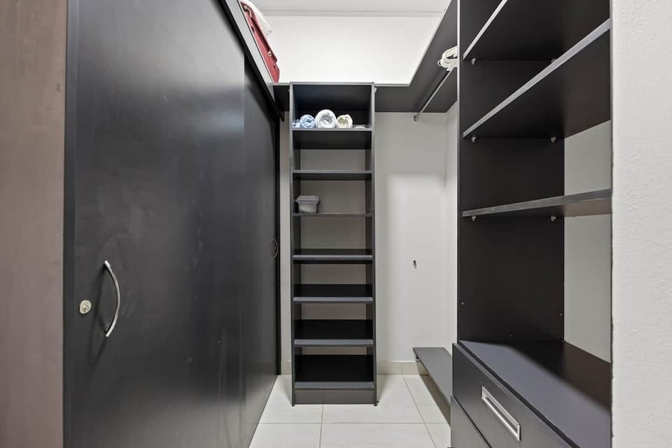 Spacious and functional walk-in closet, ideal for organizing clothes and luggage for longer stays