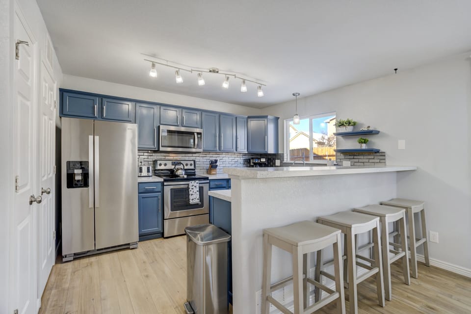 The fully equipped kitchen includes ample counter space and storage
