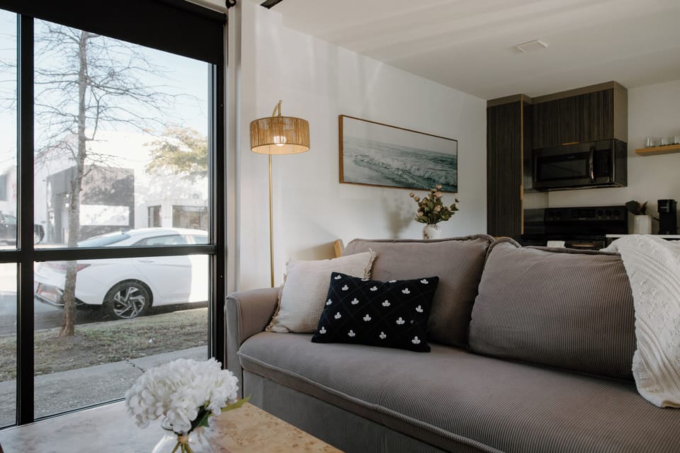 Relax in the cozy downstairs living space equipped with a Roku Smart TV, high-speed Wi-Fi, and a fold-out couch for additional sleeping space.